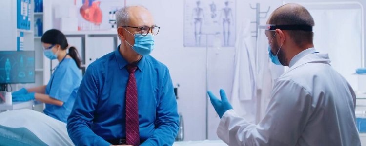 senior-man-at-doctor-appointment-during-covid-19-JJ7BUVY (1)